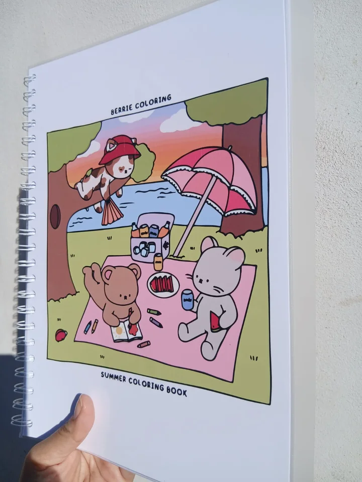 Cuaderno anillado para pintar abierto con una ilustración de picnic